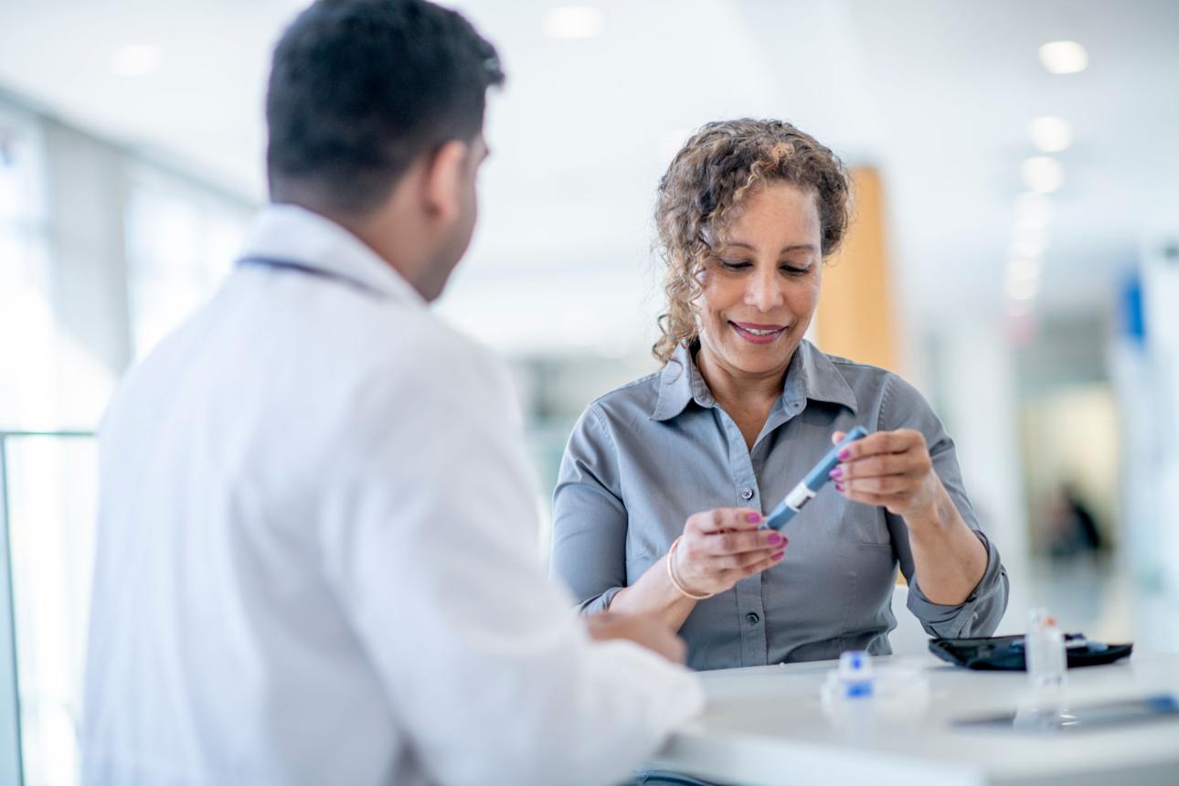 An adult discussing diabetes care with a clinician